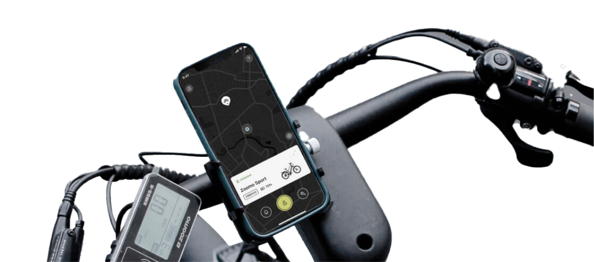 Smartphone on bicycle handlebar showing a map and a Zoomo Sport bike app interface.