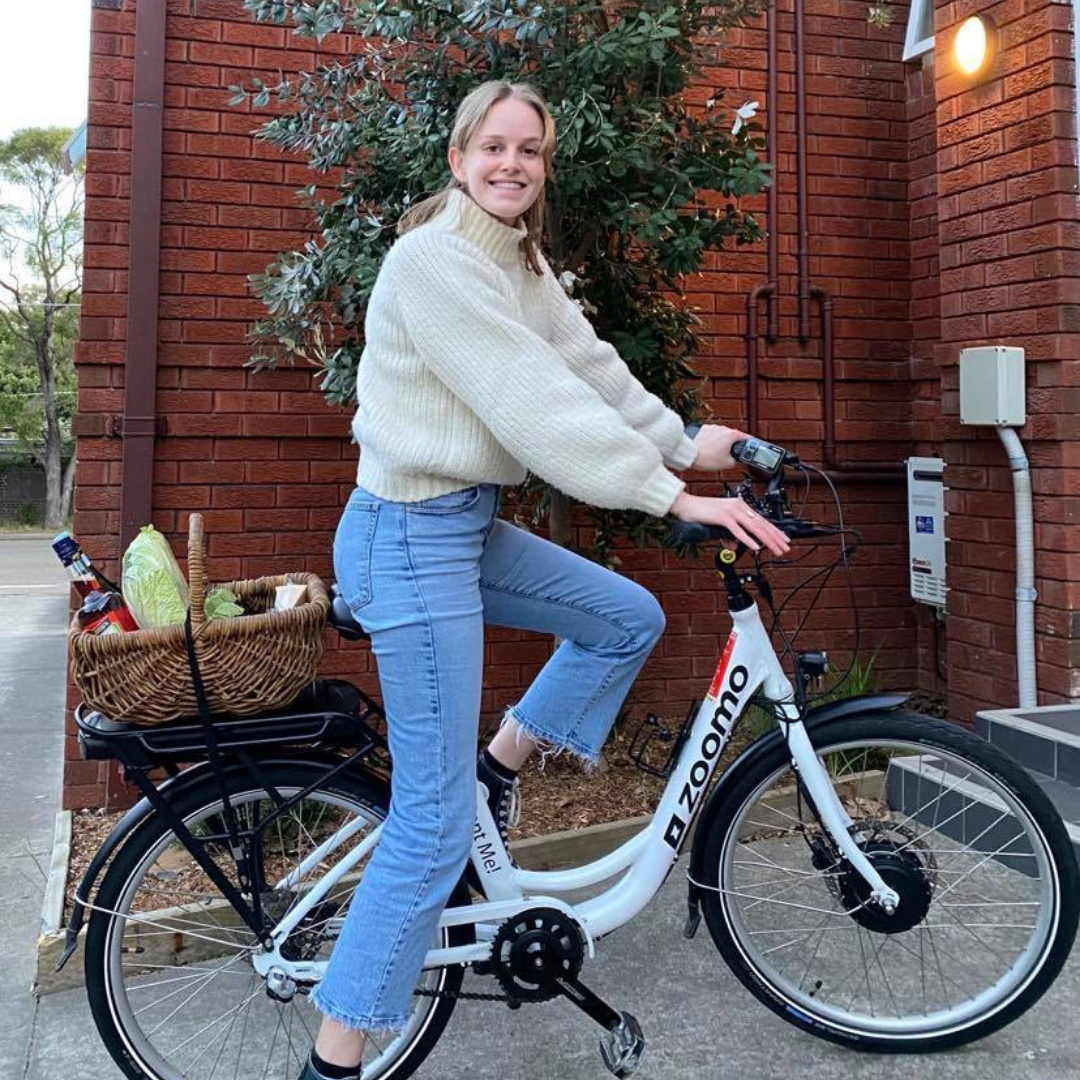 Woman riding an electric bike to do her grocery shopping